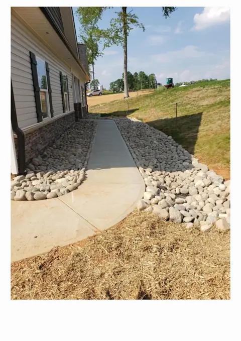 River rock drainage path along a home in Charlotte NC